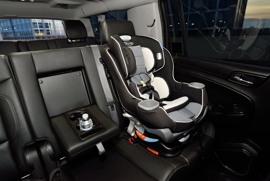 Safety car seat securely installed in the back of a modern vehicle. Ideal for family travel.